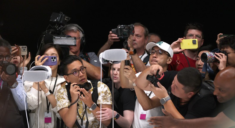 A media scrum for pictures of the Vision Pro on display.Justin Sullivan/Getty Images