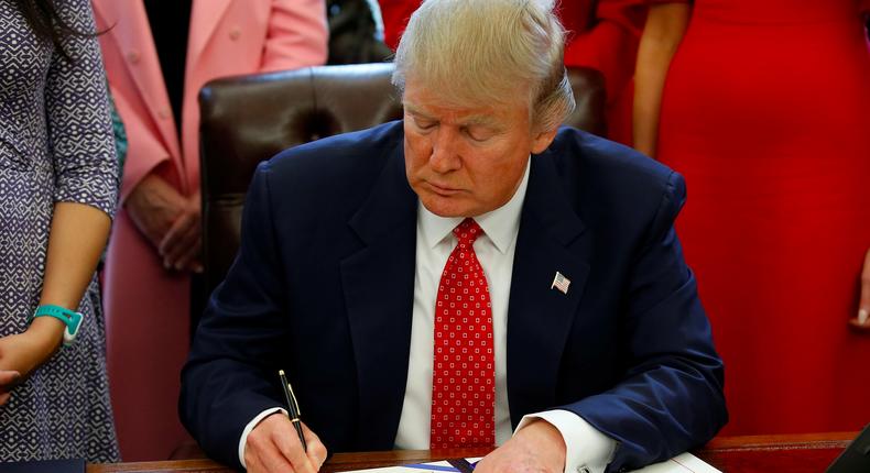 President Donald Trump signing H.R. 225 in the Oval Office on February 28.