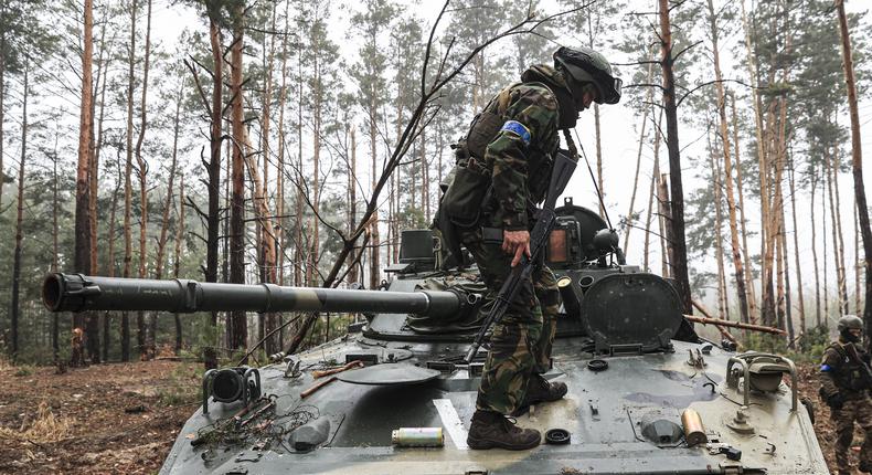 A Russian tank seized inside of the woodland is examined by Ukrainian soldiers in Irpin, Ukraine on April 01, 2022.Metin Aktas/Anadolu Agency via Getty Images