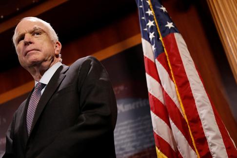 Senator John McCain (R-AZ) looks on during a press conference about his resistance to the so-called 