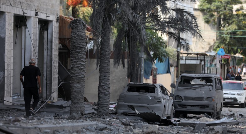 Palestinian men walk amid the rubble of a UN school in Gaza City, which was destroyed in an Israeli airstrike.Majdi Fathi/NurPhoto via Getty Images