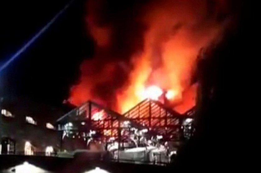 Firefighters spray water onto a fire at Camden Market in London