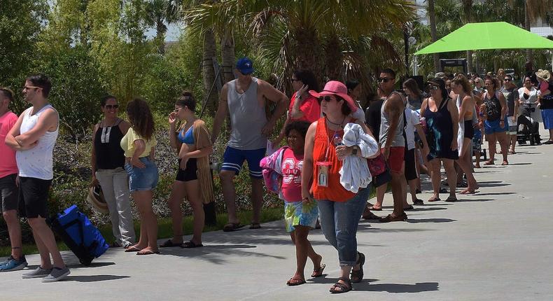 People wait in a queue to enter Island H2O Live! water park in the Orlando area over Memorial Day weekend.