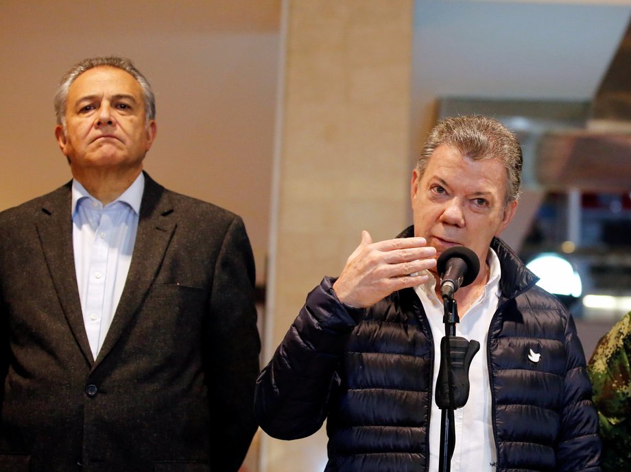 Colombian President Juan Manuel Santos, center, next to Vice President Oscar Naranjo, in Bogota, June 17, 2017.