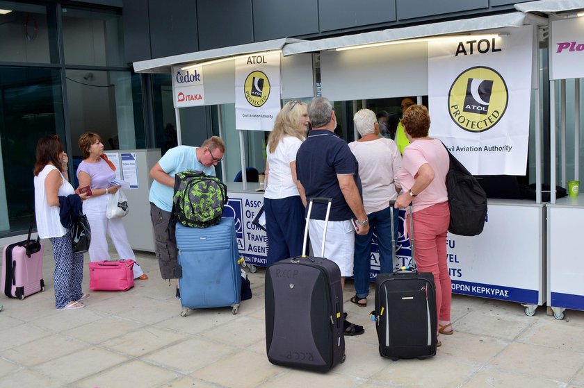 A television crew film outside of a closed Thomas Cook store in London