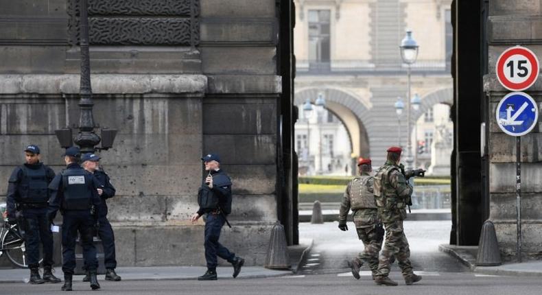 Police and soldiers patrol outside the Louvre on February 3, 2017 in Paris