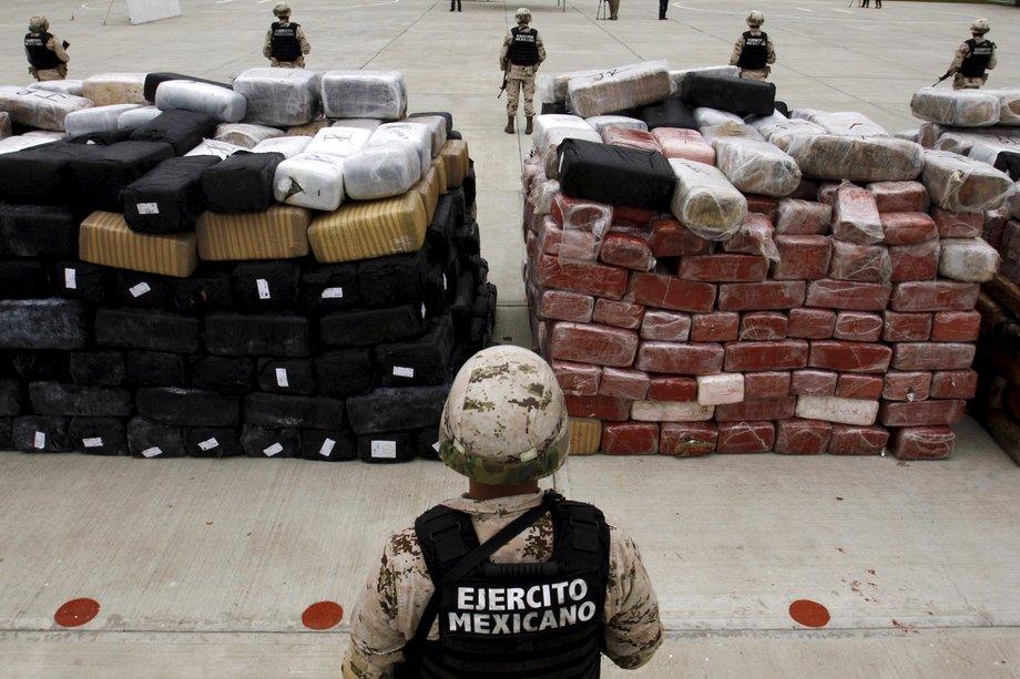 Soldiers stand guard next to packages of marijuana at the 28th Infantry Battalion in Tijuana, Mexico, June 13, 2015.