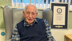 John Tinniswood and his Guinness World Records certificate for becoming the world's oldest man.Guinness World Records