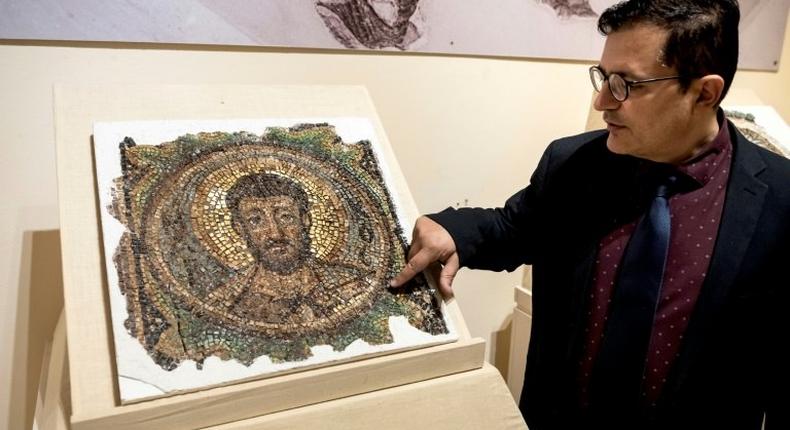 Director of the Cyprus Byzantine Museum Ioannis Eliades shows a centuries-old mosaic of Saint Mark in Nicosia on November 21, 2018