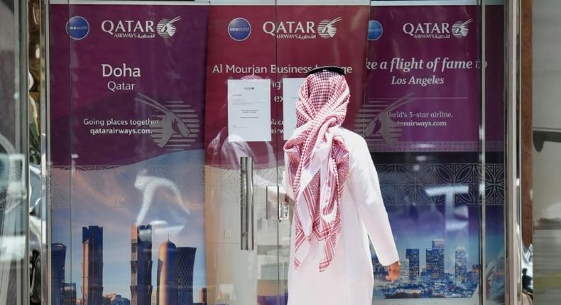 A man stands outside a Qatar Airways branch in the Saudi capital Riyadh, after it was forced to suspended all flights to Saudi Arabia