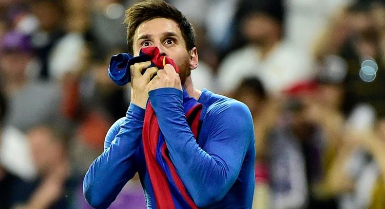 Iconic: Lionel Messi kisses his jersey after celebrating his last-minute goal against Real Madrid in 2017 Creator: GERARD JULIEN