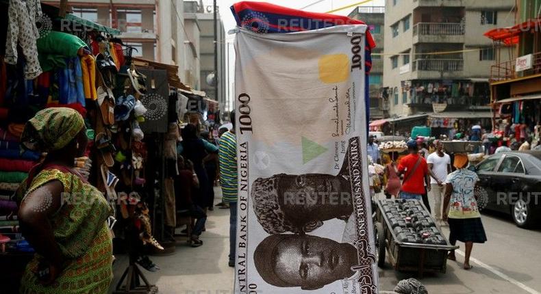 A towel with a print of the Nigerian naira is displayed for sale at a street market in the central business district in Nigeria's commercial capital Lagos February 4, 2016. 