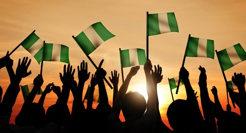 Nigerian citizens holding the Nigerian flags (Lionesses of Africa)