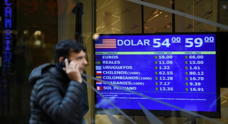 Currency exchange values are displayed on the buy-sell board in Buenos Aires, on August 13, 2019