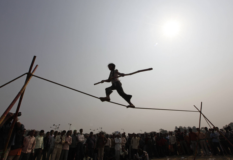 Eight-year-old Rupa performs on a tightrope at a roadside in Kolkata