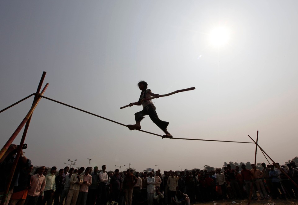 Eight-year-old Rupa performs on a tightrope at a roadside in Kolkata