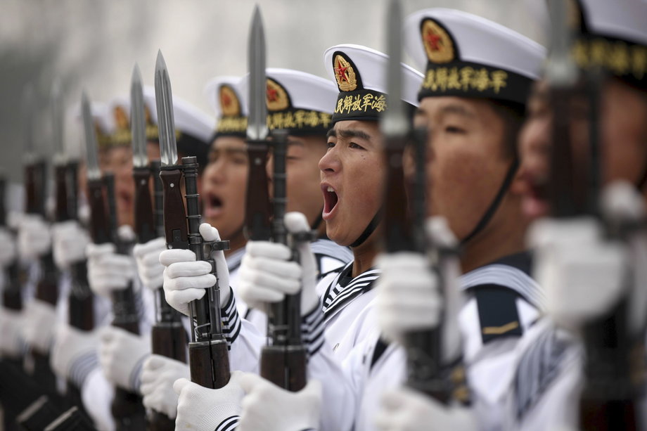 Chinese People's Liberation Army Navy recruits chant slogan during a parade to mark the end of a semester at a military base of the North Sea Fleet, in Qingdao, Shandong province December 5, 2013.