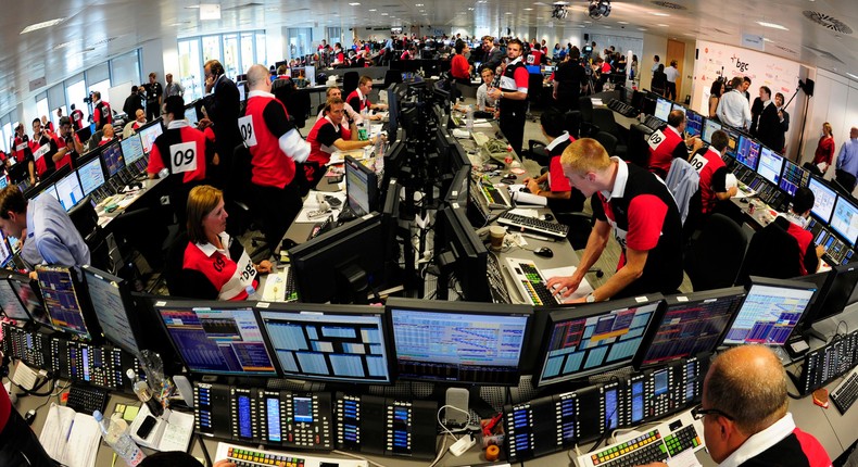 Dealers work on the trading floor of BGC Partners in the Canary Wharf financial district in east London.