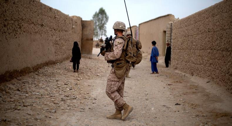 A U.S. Marine with Task Force Southwest moves through a village during a patrol near Bost Kalay, Afghanistan.