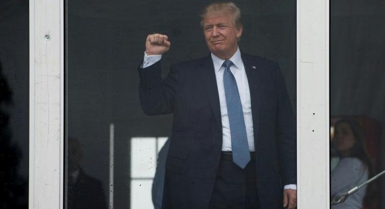 US President Donald Trump acknowledges spectators as he arrives at the 72nd US Women's Open Golf Championship at Trump National in Bedminister, New Jersey, July 14, 2017