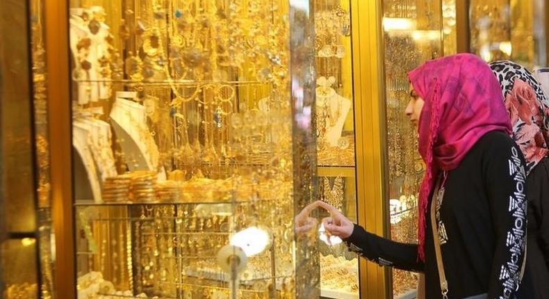 Women look at jewellery at a shop in a gold market in Basra, southeast of Baghdad February 14, 2015. 