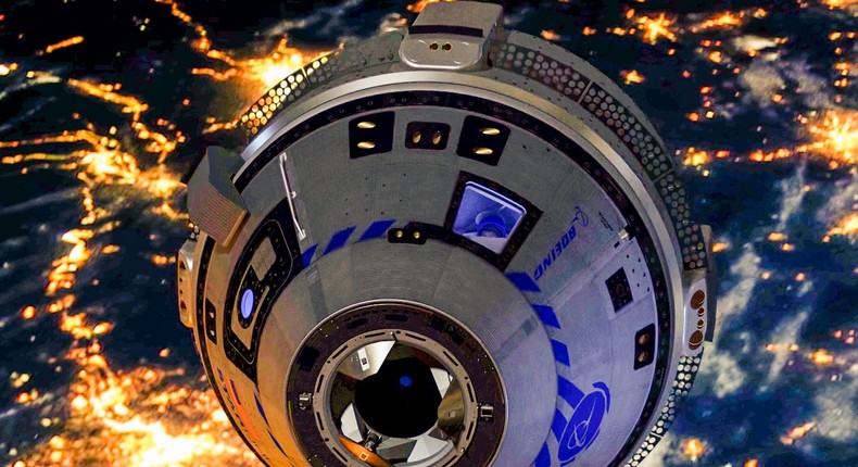 A computer rendering of Boeing's CST-100 Starliner spaceship orbiting Earth.
