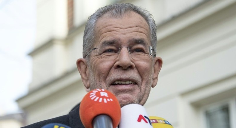 Alexander Van der Bellen, candidate for presidential election talks to journalists as he leaves the polling station on December 4, 2016