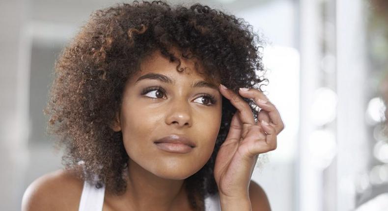 Woman applying vaseline on her eyebrows