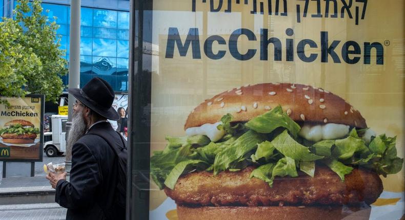 An Orthodox Jewish man stands near a sign for the McDonald's McChicken sandwich on June 13, 2022 in Jerusalem, Israel.Alexi Rosenfeld/Getty Images