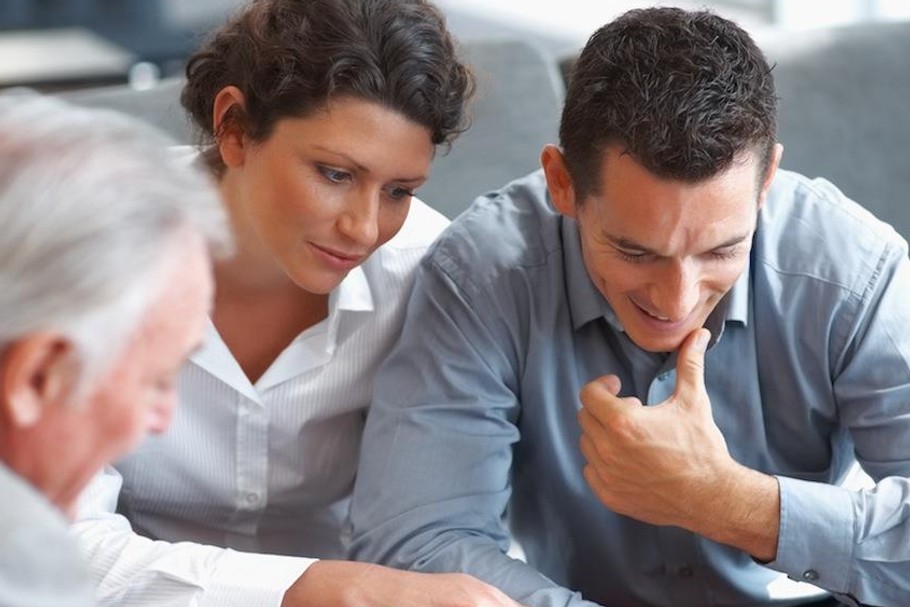 Banking agent explaining an investment scheme to a couple