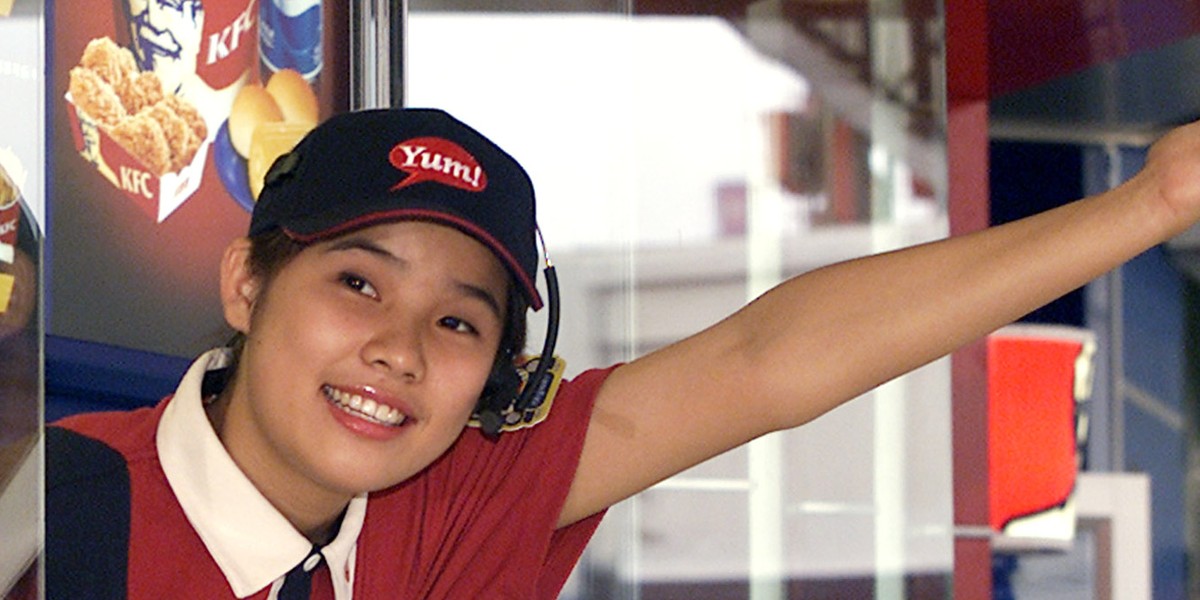 A Kentucky Fried Chicken employee welcomes a customer at China's first drive-through restaurant in Beijing September 3, 2002.