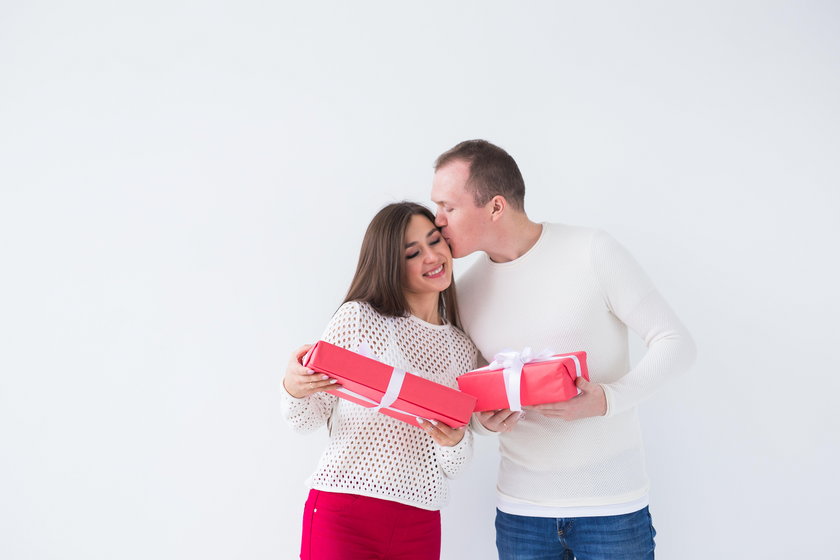 Christmas, holidays, Valentine's day and birthday concept - Happy man and woman holds boxes with gif