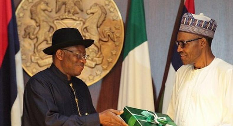 Former President Goodluck Jonathan presenting hand-over documents to President Muhammadu Buhari