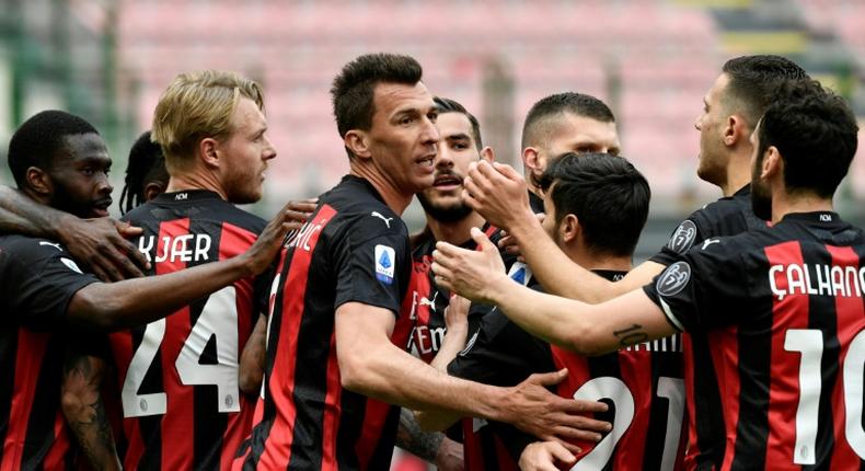 Mario Mandzukic (C) returned from injury as Milan ended their two-month home drought against Genoa.