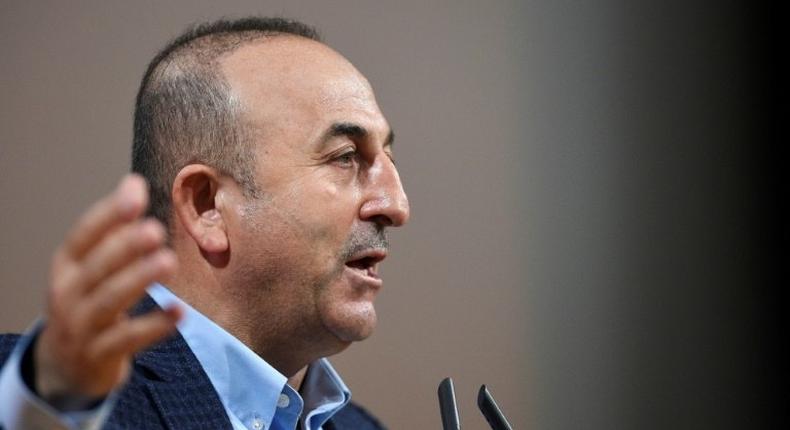 Turkish Foreign Minister Mevlut Cavusoglu threatens to unilaterally scrap migrant deal with the EU amid escalating diplomatic crisis