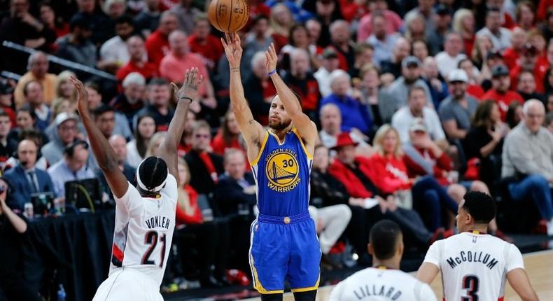 Stephen Curry of the Golden State Warriors shoots the ball over Noah Vonleh of the Portland Trail Blazers in Game Three of the Western Conference quarter-finals of the 2017 NBA Playoffs, in Portland, Oregon, on April 22