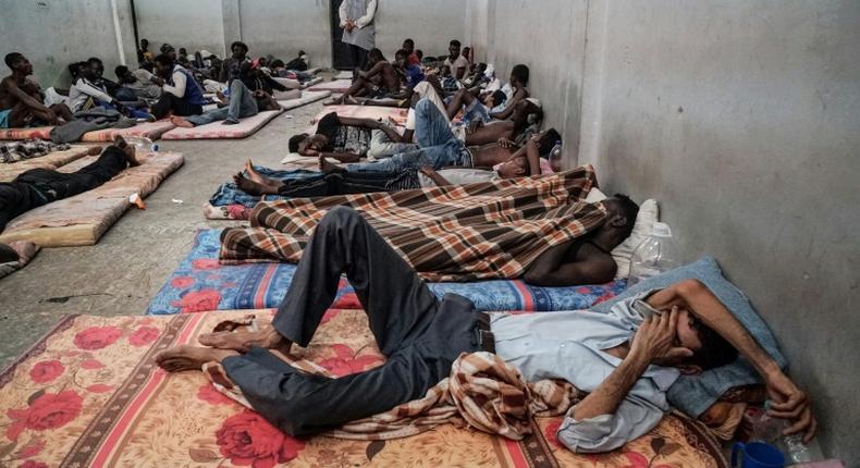 (FILES) In this file photo taken on June 17, 2017 illegal immigrants are seen sleeping at a detention centre in Zawiyah, 45 kilometres west of the Libyan capital Tripoli. The heads of two refugee agencies have called for refugees and migrants held in Libyan centres to be freed and for countries to take them in