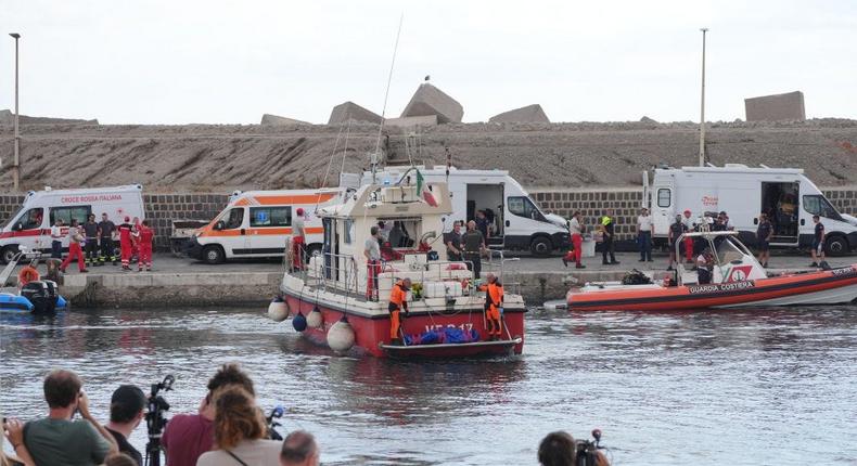 Rescue workers at a harbor in Porticello.Jonathan Brady - PA Images