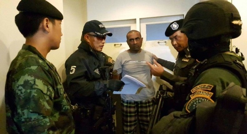 Pakistani national Abdul Rehman (C), was arrested in Bangkok and is suspected of being part of an extortion gang that burned down a Karachi factory in 2012 killing 259