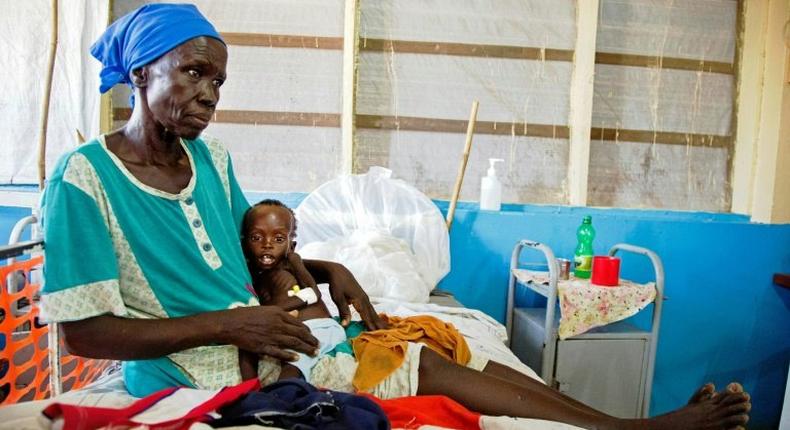 Regina Aluel holds her grandson Agop Manut, 11-months-old, who suffers acute malnutrition and respiratory distress at the clinic run by Doctors Without Borders in Aweil, northern Bahr al-Ghazal, South Sudan in 2016