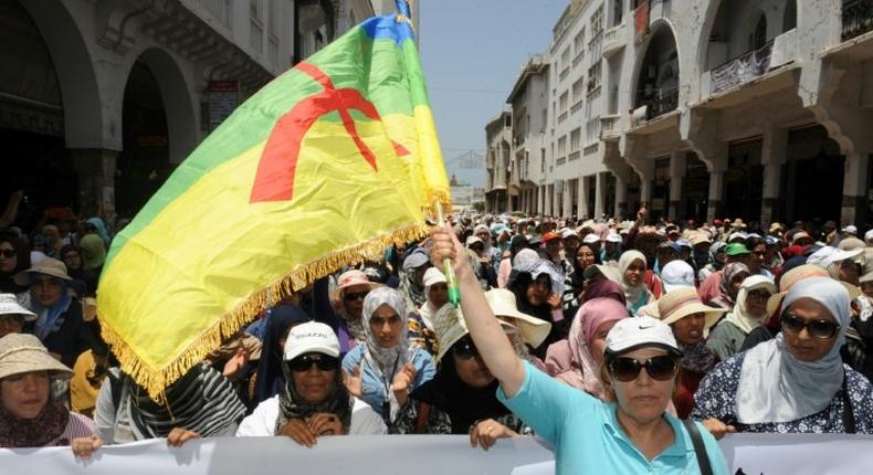 A protester waves a flag of the Amazigh, Morocco's Berber community, during a demonstration in downtown Rabat on June 11, 2017