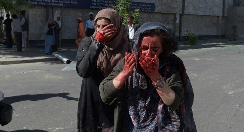 Wounded Afghan women at the site of a car bomb attack in Kabul that killed scores of people on May 31, 2017