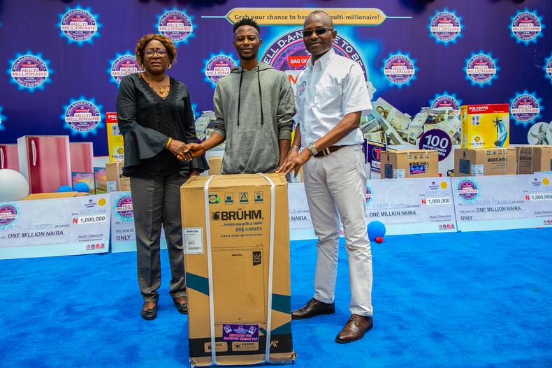 Paul Ojo, winner of 2 refrigerators with team members of  Dangote Cement, Plc 