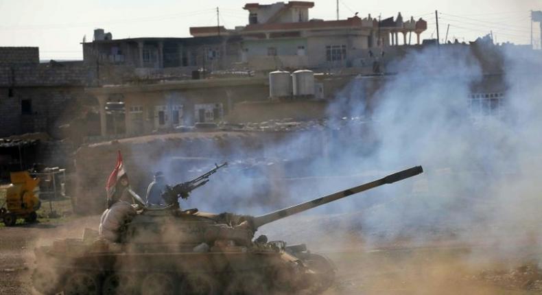 Iraqi government forces supported by fighters from the Abbas Brigade, advance in village of Badush some 15 kilometres northwest of Mosul during the ongoing battle to retake the city's west from Islamic State group March 7, 2017