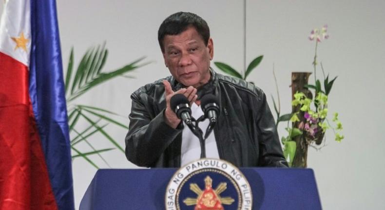 Philippine President Rodrigo Duterte gestures as he speaks shortly after arriving in Davao on May 16, 2017, from a working visit to China.Duterte said on May 16 he was open to jointly exploration with Beijing resources in the disputed South China Sea, following a meeting with Chinese President Xi Jinping.