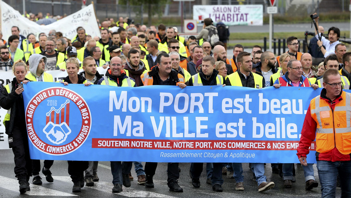 Harbor workers, storekeepers and residents march to participate in a human chain protest demonstration against the migrant situation in Calais