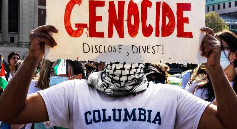 A protester holds up a sign at a protest on Columbia's campus. Demonstrators are demanding the school divest from Israel.Alex Kent; Getty Images