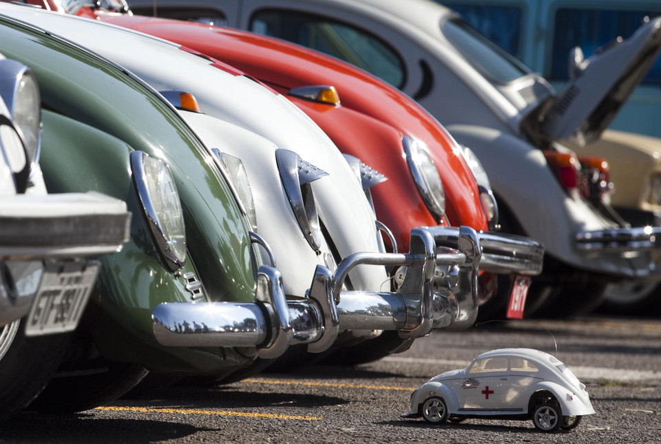 A Volkswagen Beetle toy is seen in front of Beetle cars during celebrations of the National day of the Beetle in Sao Bernardo do Campo