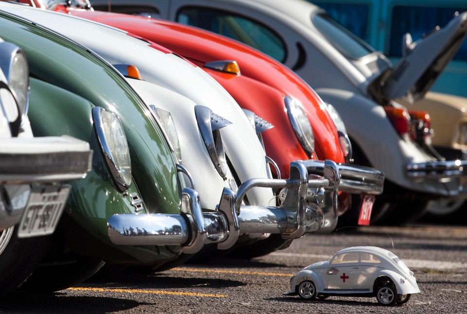 A Volkswagen Beetle toy is seen in front of Beetle cars during celebrations of the National day of the Beetle in Sao Bernardo do Campo