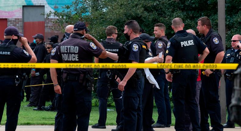 Members of the Louisville Metro Police Department congregate around the place where Breonna Taylor was shot during a rally to protest her killing, in Louisville, Kentucky, on July 25, 2020.Jeff Dean/AFP via Getty Images